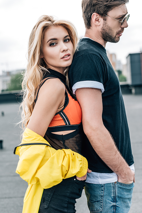 blonde and attractive woman in yellow jacket with handsome man in glasses