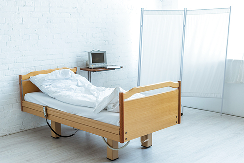 empty bed and medical equipment in ward in clinic