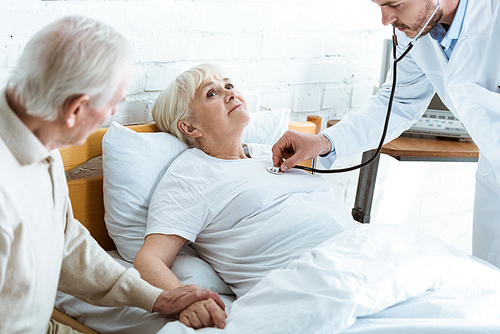 partial view of doctor examining sick patient and senior man