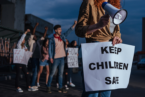 cropped view of girl holding placard with keep children safe lettering near multicultural people on meeting