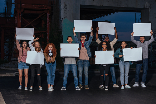 emotional multicultural young people holding blank placards on meeting