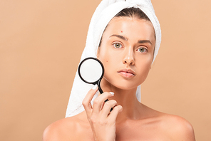 naked woman with pimples on face holding magnifier isolated on beige