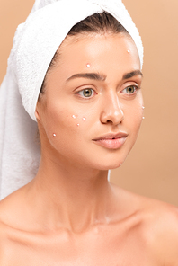 naked young woman in acne on face and white towel isolated on beige