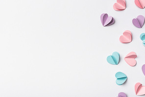 top view of colorful paper hearts on white background