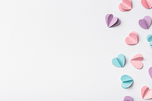 top view of colorful paper hearts on white background