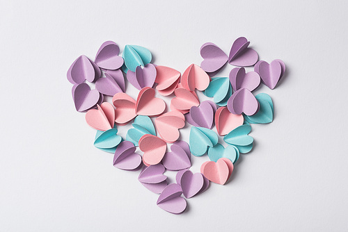 top view of small paper hearts on white background