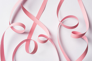 top view of pink paper swirl on white background