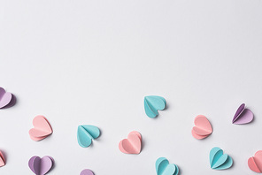 top view of small paper hearts on white background