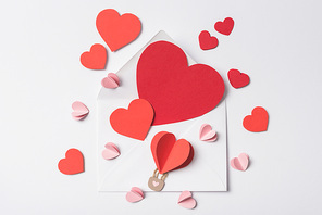 top view of red hearts on envelope on white background