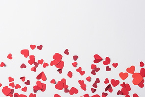 top view of red hearts scattered on white background