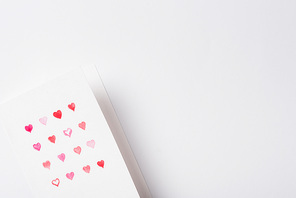 top view of valentines greeting card with red hearts on white background