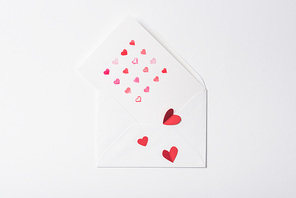 top view of valentines greeting card in envelope with red hearts on white background