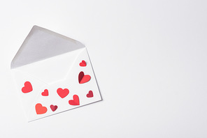 top view of valentines envelope with red hearts on white background