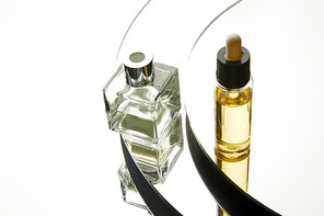 High angle view of perfume bottle and serum bottle on mirror surface
