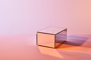 cube with light reflection on surface on violet and pink background