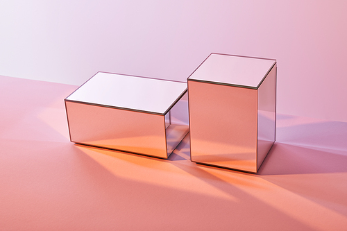 cubes with light reflection on surface on pink background