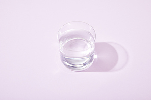 glasses of fresh water on violet background