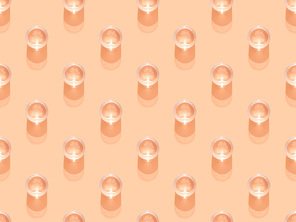 top view of glasses of water on orange, seamless background pattern