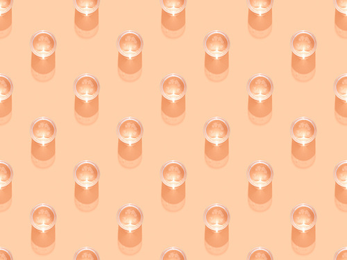 top view of glasses of water on orange, seamless background pattern