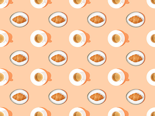 top view of fresh croissants on plates and coffee on orange, seamless background pattern