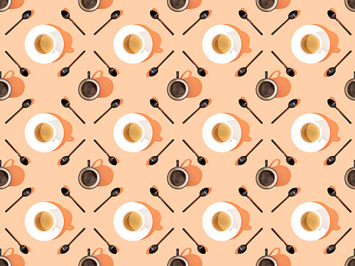 top view of cups of fresh coffee on plates and spoons on orange, seamless background pattern