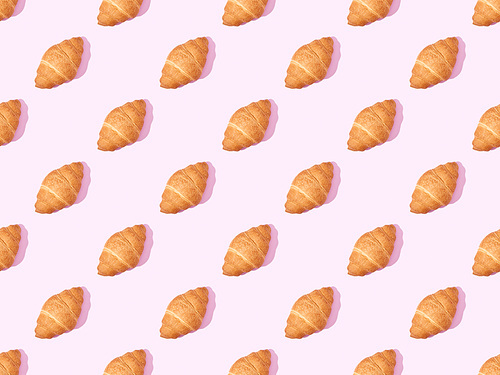 top view of croissants on pink, seamless background pattern