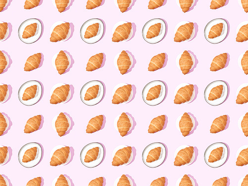 top view of croissants on plates on pink, seamless background pattern