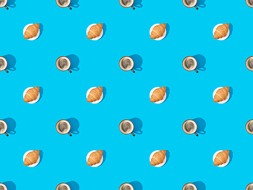 top view of croissants on plates and coffee on blue, seamless background pattern