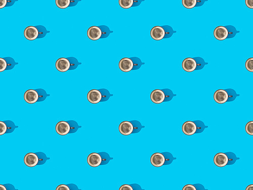 top view of cups of fresh coffee on blue, seamless background pattern