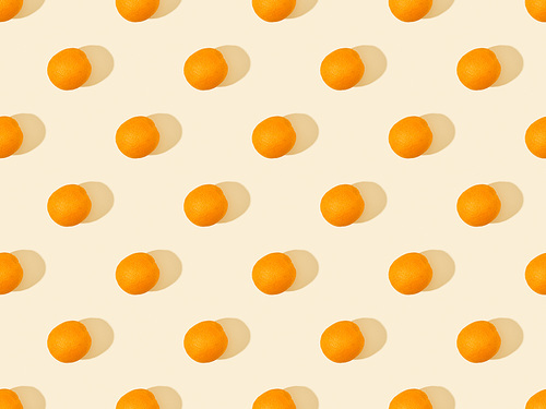 top view of ripe delicious oranges ob beige, seamless background pattern