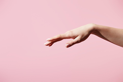 Cropped view of female hand isolated on pink