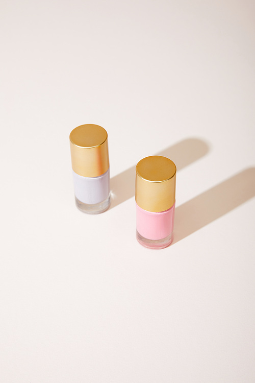 High angle view of bottles of nail polish on white background