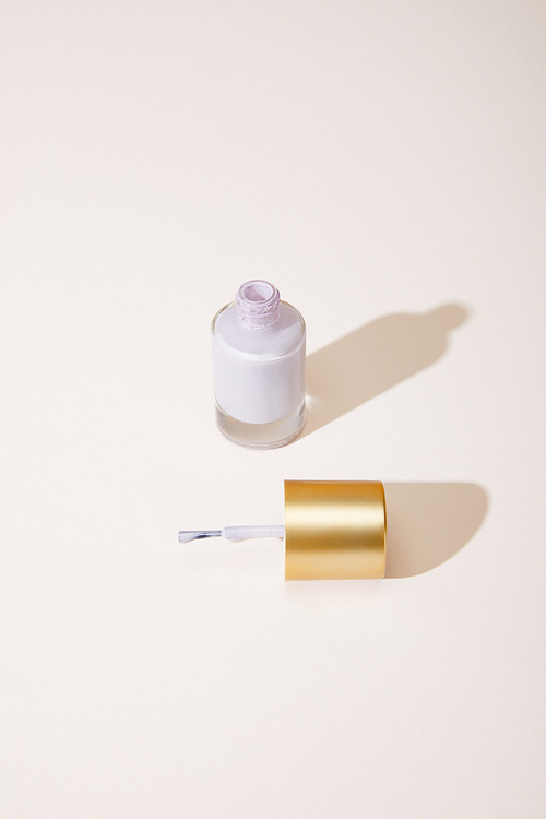 High angle view of opened bottle of nail polish on white background