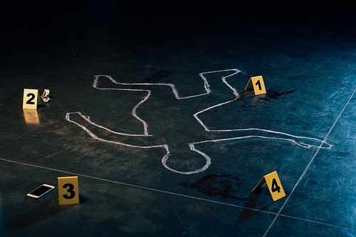 chalk outline and evidence markers at crime scene