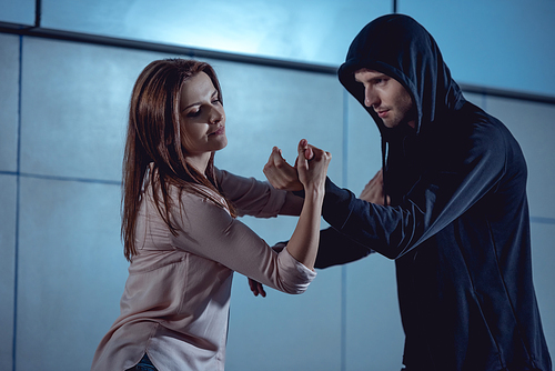 beautiful woman fighting with thief in underpass