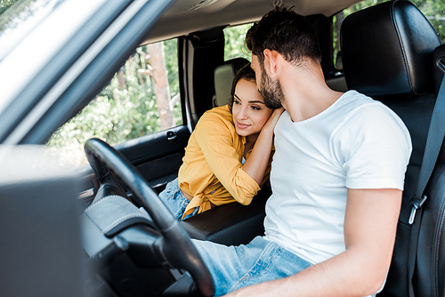 selective focus of woman near bearded man in car