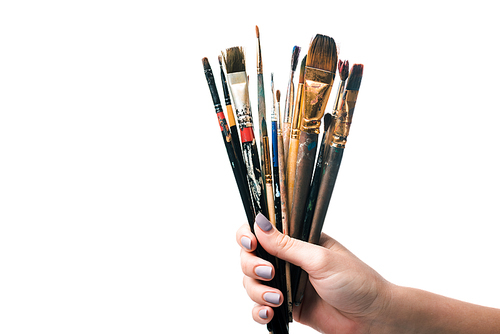 cropped view of woman holding paintbrushes isolated on white