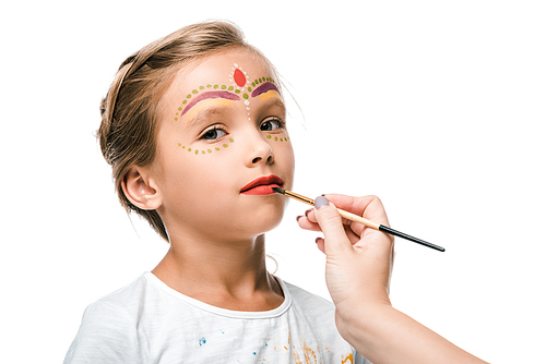 cropped view of woman holding paintbrush near child with face painting isolated on white