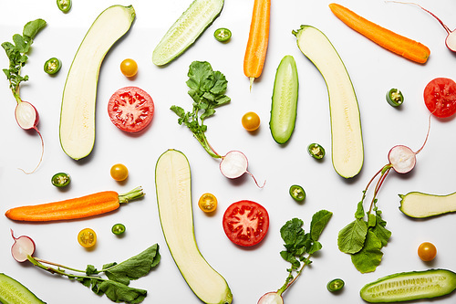 top view of fresh sliced vegetables on white background
