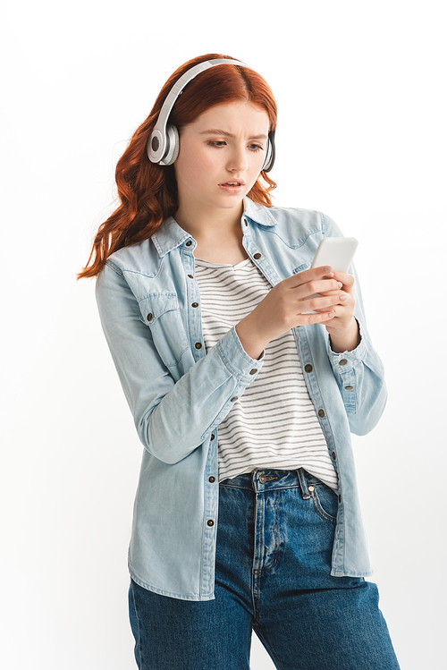 beautiful teen girl listening music with headphones and using smartphone, isolated on white