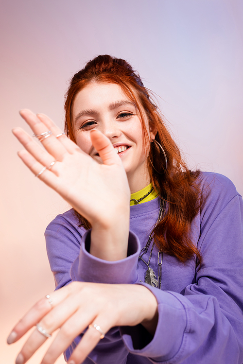 beautiful smiling redhead teen girl, on purple and beige