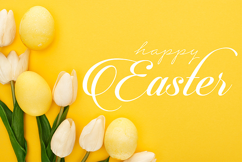 top view of tulips and painted Easter eggs on colorful yellow background with happy Easter illustration