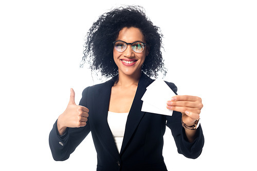Happy african american businesswoman showing thumb up and business cards isolated on white