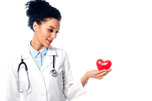 Front view of african american doctor showing decorative heart with outstretched hand isolated on white