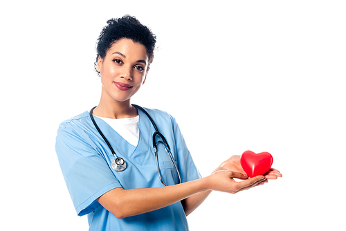 African american nurse with stethoscope showing decorative red heart  isolated on white