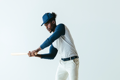serious african american sportsman playing baseball isolated on grey