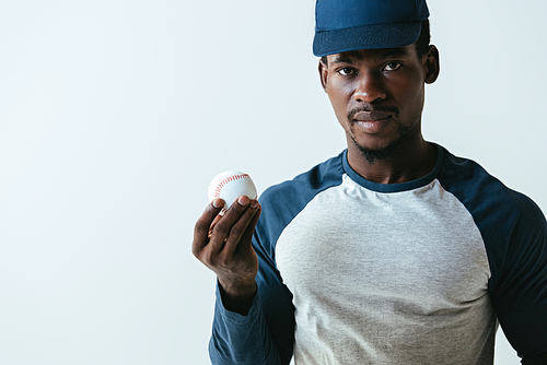 handsome african american  player  while holding ball isolated on grey