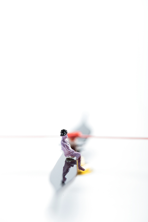 Selective focus of people figure on arrow of clock on white background with copy space, concept of senescence