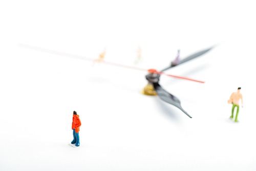 Selective focus of people figures and black and red arrows of watch on white background, concept of senescence