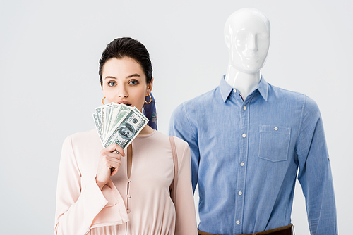 beautiful girl near mannequin holding money isolated on grey
